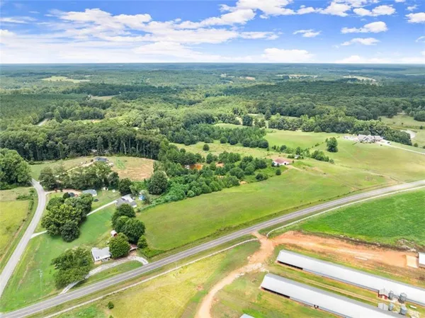 an aerial view of residential houses with outdoor space and river