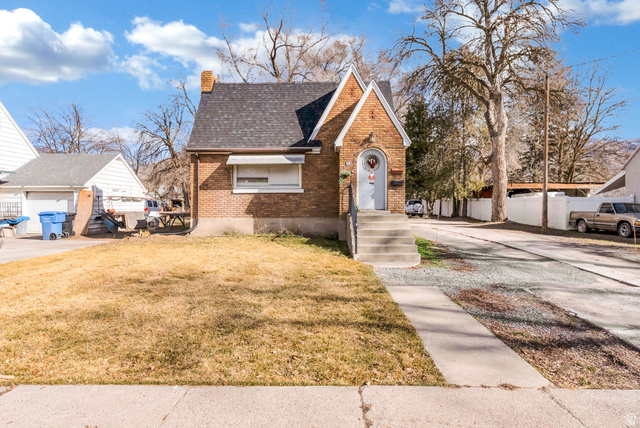 654 North 100 East Logan, UT 84321 - Photo 2 of 41 Tudor home with a chimney, brick siding, and roof with shingles