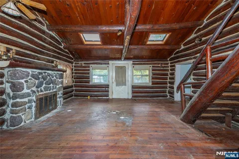 a view of an empty room with stairs and windows