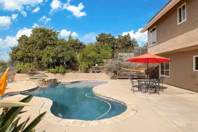 an outdoor space with pool and furniture