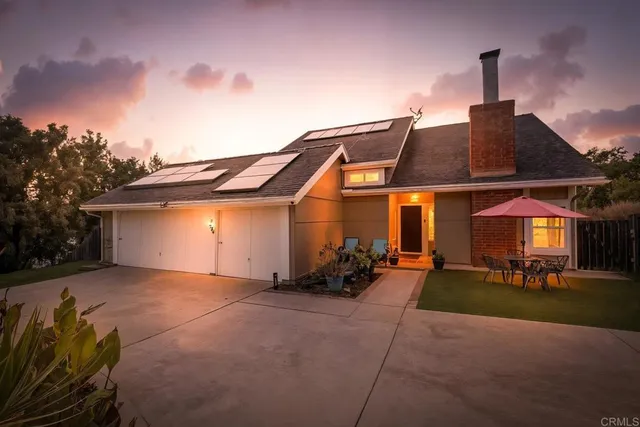 a kitchen with stainless steel appliances granite countertop a refrigerator a sink dishwasher a stove and a dining table with wooden floor