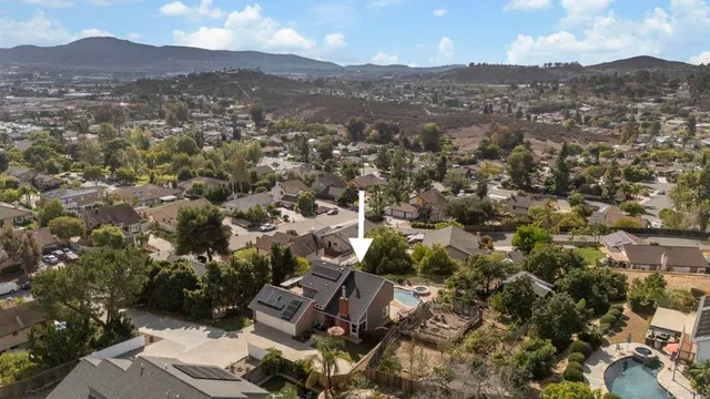 a front view of a house with a yard and potted plants