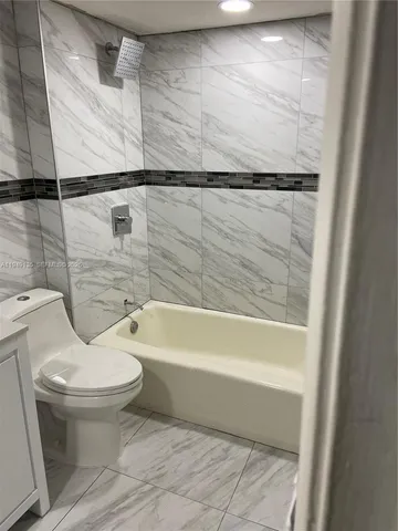 a bathroom with a toilet and a bathtub