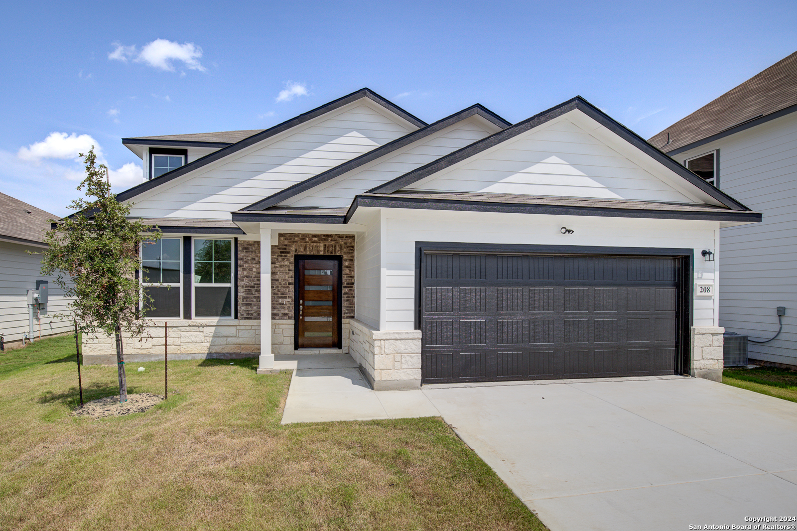 a front view of a house with a yard and garage