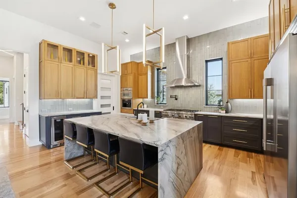 a kitchen with a stove a sink and a refrigerator
