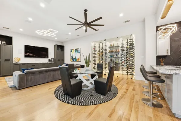 a living room with furniture a flat screen tv and a floor to ceiling window