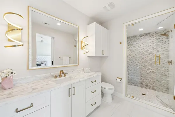 a bathroom with a granite countertop sink mirror and double