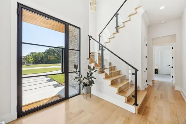 a view of entryway and hall with wooden floor