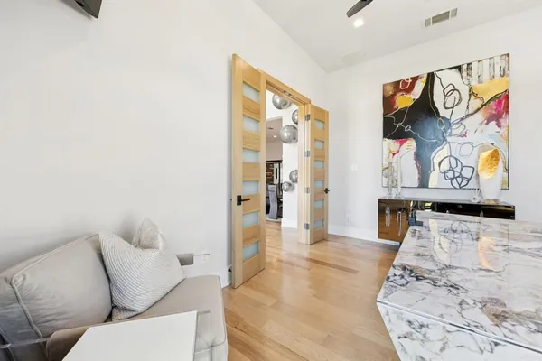 a living room with furniture and wooden floor