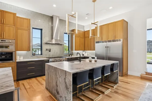 a kitchen with a sink a stove a refrigerator and cabinets