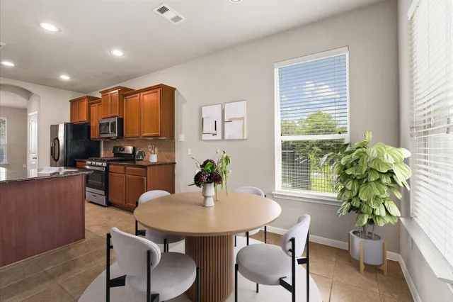 a kitchen with a table and chairs in it