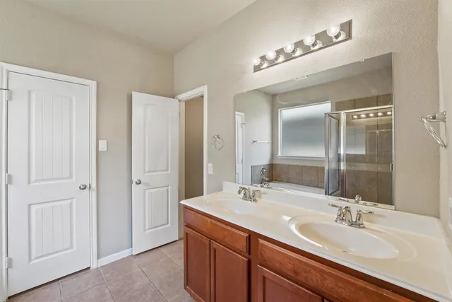 a bathroom with 2 sink and a mirror