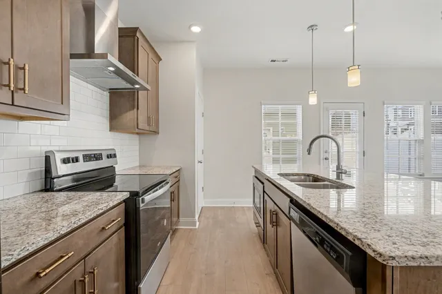 a kitchen with granite countertop stainless steel appliances and wooden cabinets