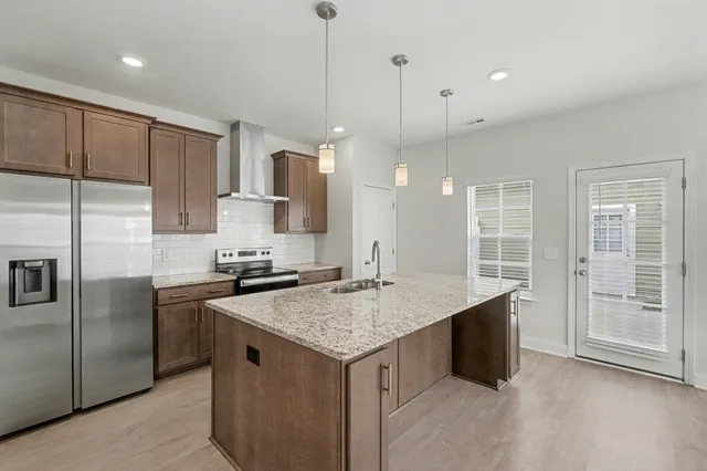 a kitchen with a sink stove and refrigerator