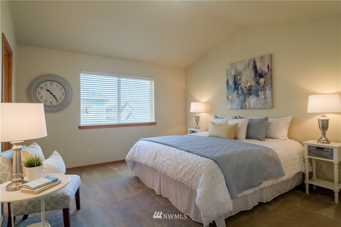 7432 Upper Ridge Road Everett, WA 98203 - Photo 12 of 32 a bedroom with a bed and wooden floor