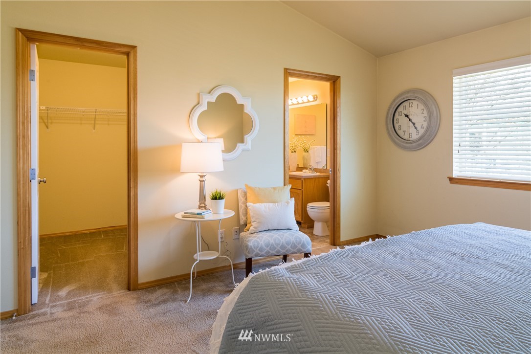 7432 Upper Ridge Road Everett, WA 98203 - Photo 13 of 32 a bedroom with a bed and a table in it next to a window