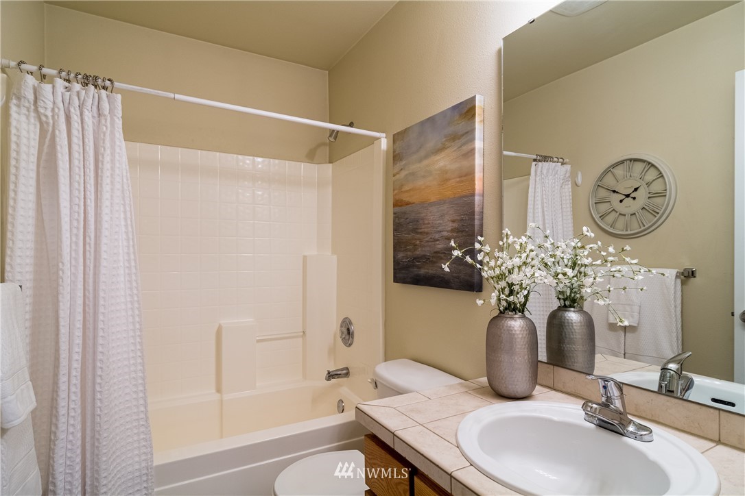 7432 Upper Ridge Road Everett, WA 98203 - Photo 15 of 32 a bathroom with a granite countertop sink a toilet and shower