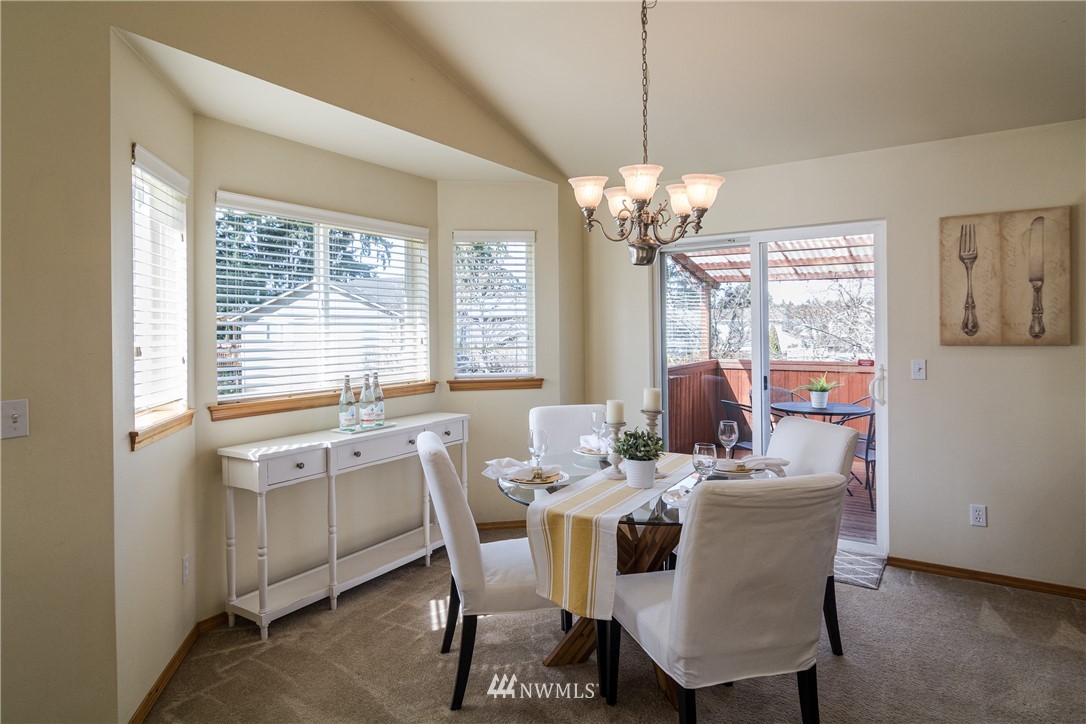 7432 Upper Ridge Road Everett, WA 98203 - Photo 10 of 32 a dining room with furniture a chandelier and window