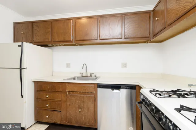 a kitchen with stainless steel appliances granite countertop a sink stove and cabinets