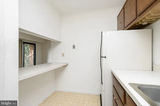 a kitchen with stainless steel appliances granite countertop a sink a stove and cabinets