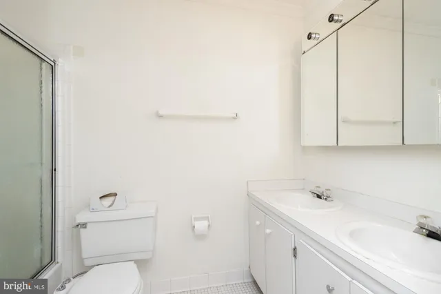 a white toilet sitting next to a shower