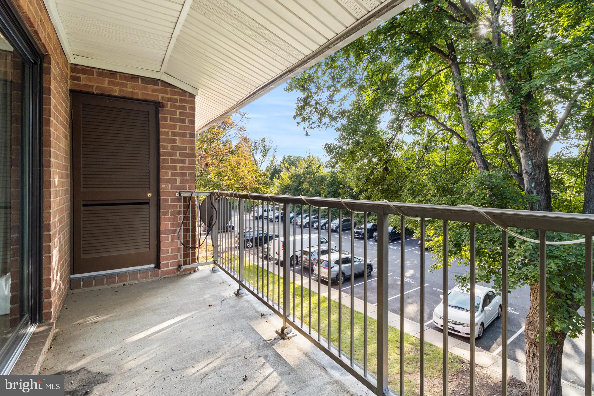 101 Fitz Court, Unit 202 Reisterstown, MD 21136 - Photo 24 of 27 a view of a balcony with a floor to ceiling window and wooden fence