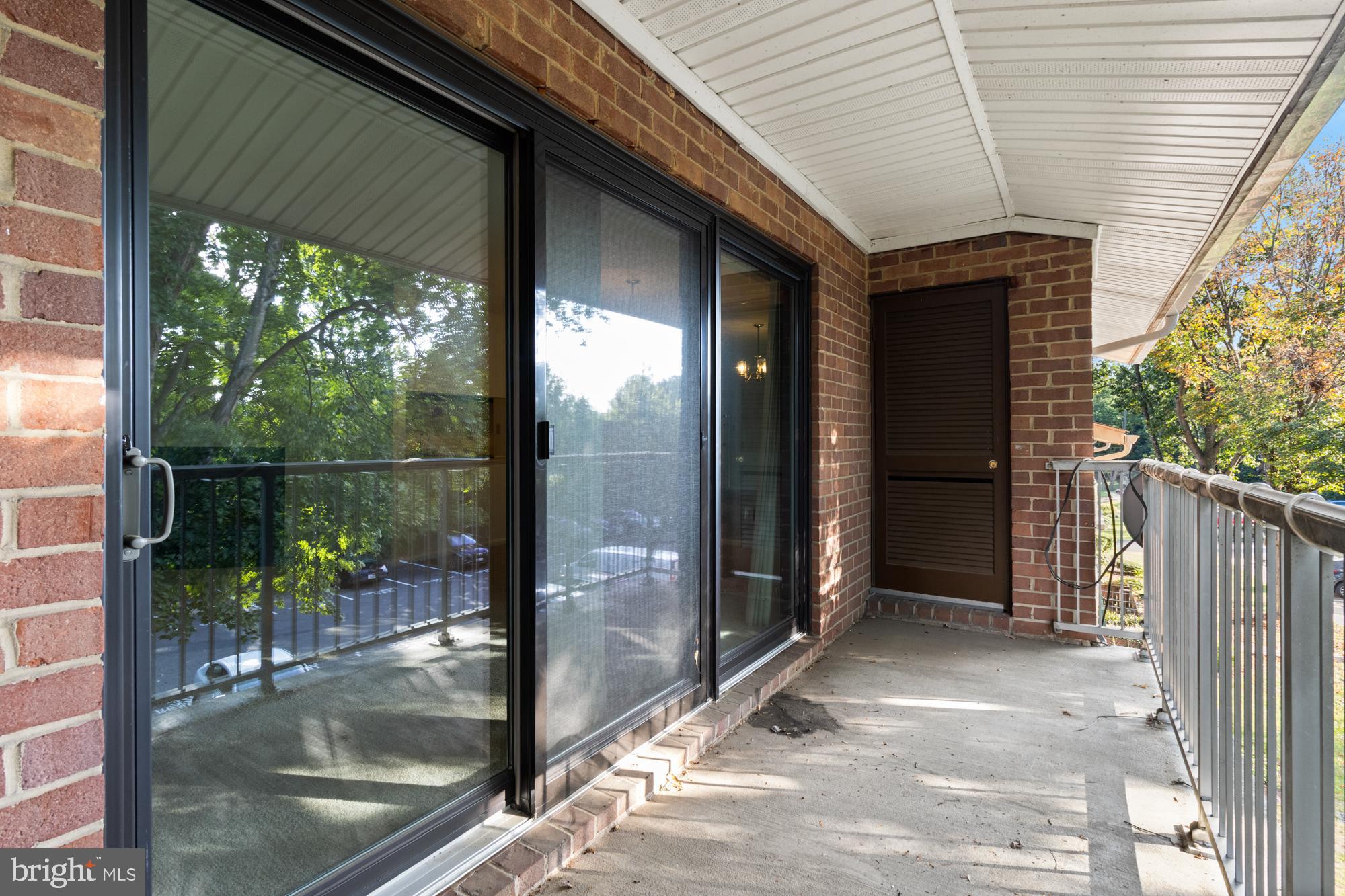 101 Fitz Court, Unit 202 Reisterstown, MD 21136 - Photo 25 of 27 a view of a porch with a floor to ceiling window and wooden floor