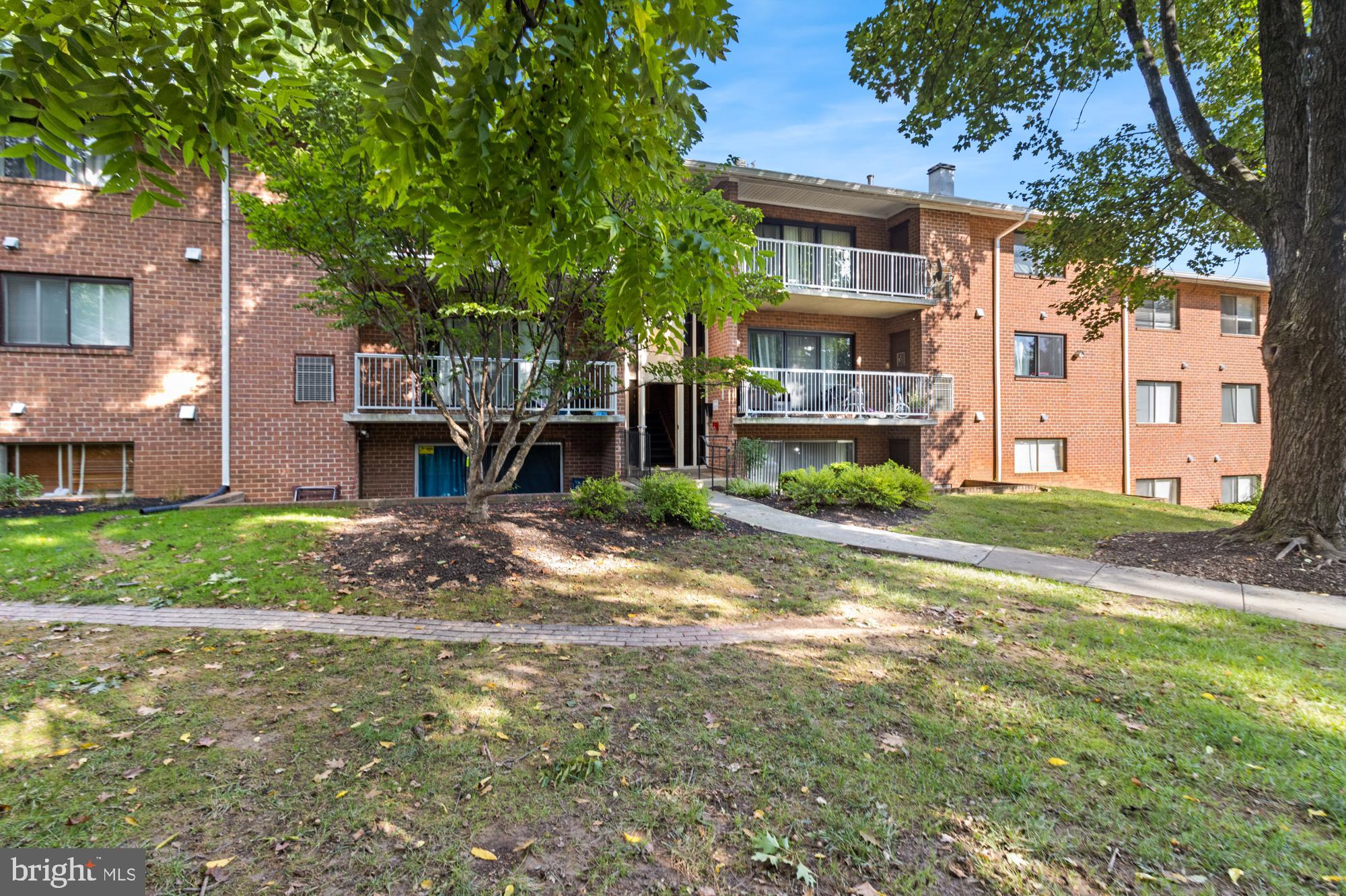 101 Fitz Court, Unit 202 Reisterstown, MD 21136 - Photo 3 of 27 a front view of a house with a yard and table and chairs