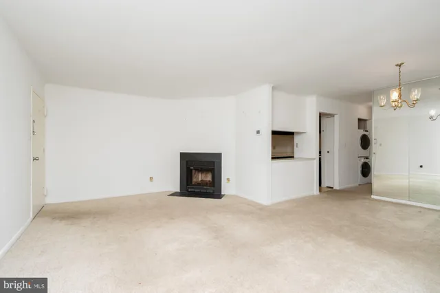 a view of an empty room with a fireplace