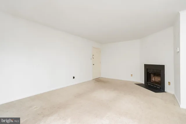 a view of empty room with a fireplace
