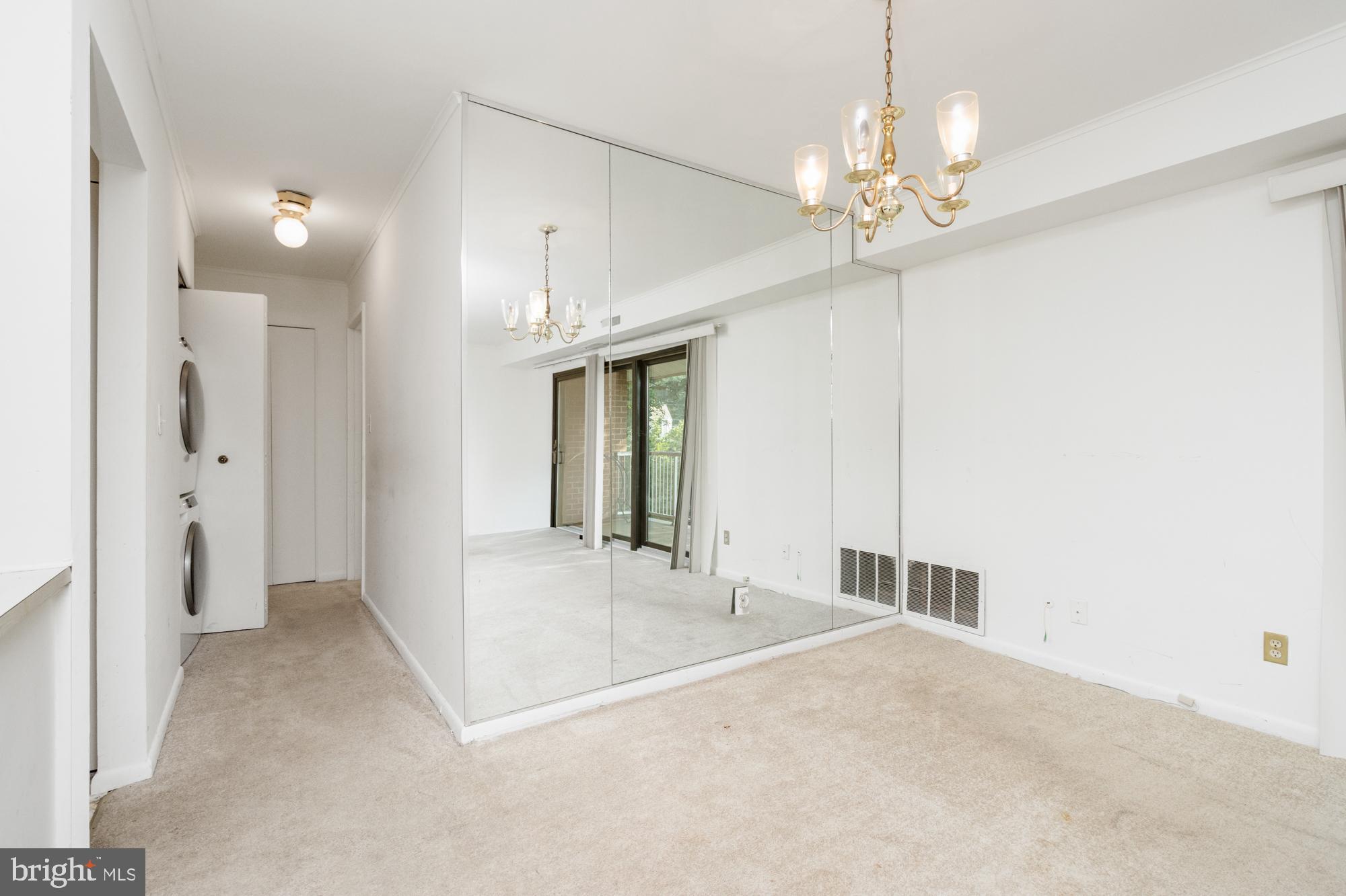 101 Fitz Court, Unit 202 Reisterstown, MD 21136 - Photo 8 of 27 a view of an empty room with a chandelier