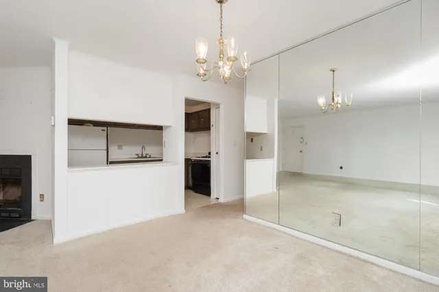 a view of a kitchen with a sink and a refrigerator