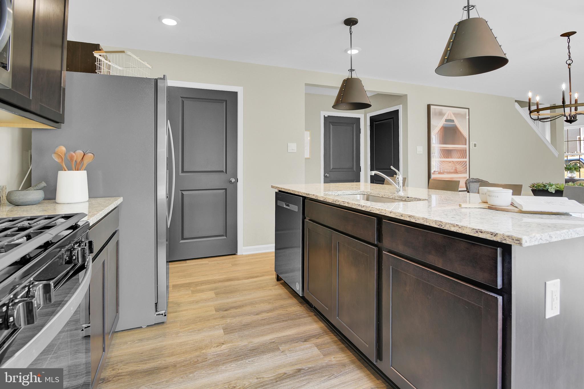 978 Pagonia Road Joppa, MD 21085 - Photo 15 of 34 a kitchen with kitchen island granite countertop a sink stainless steel appliances and cabinets