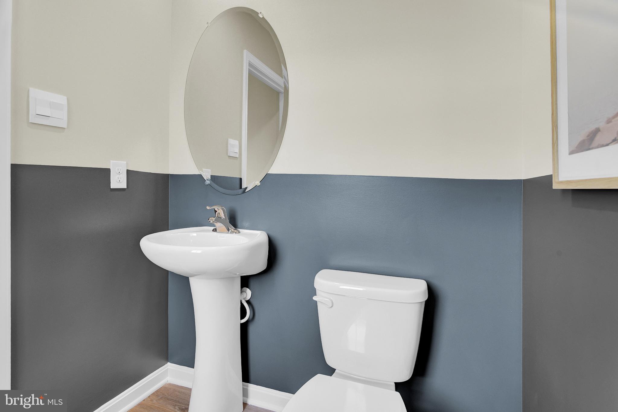 978 Pagonia Road Joppa, MD 21085 - Photo 4 of 34 a bathroom with a toilet sink and mirror