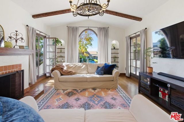 a living room with furniture fireplace and flat screen tv