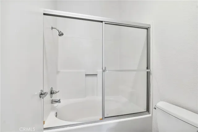 a bathroom with a shower and a bath tub