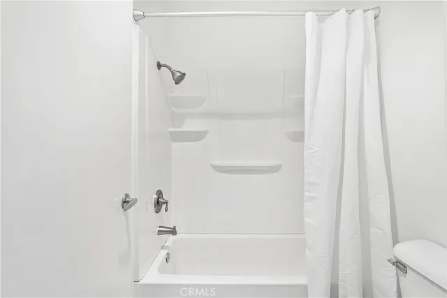 a bathroom with a tub and shower