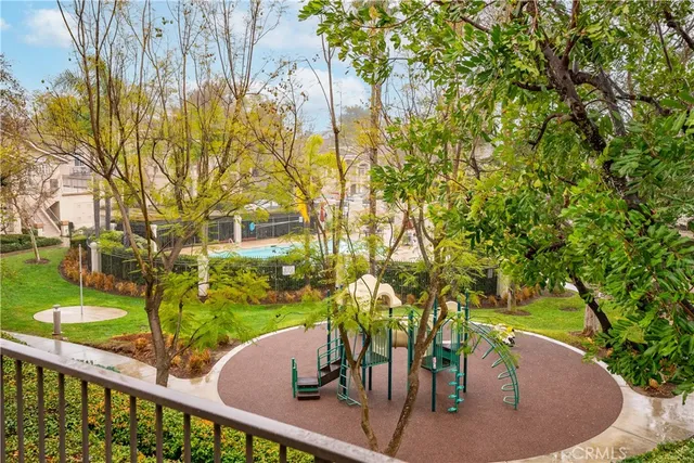 a view of a brick house with a large trees