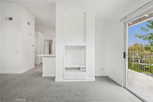 a view of an empty room and a window