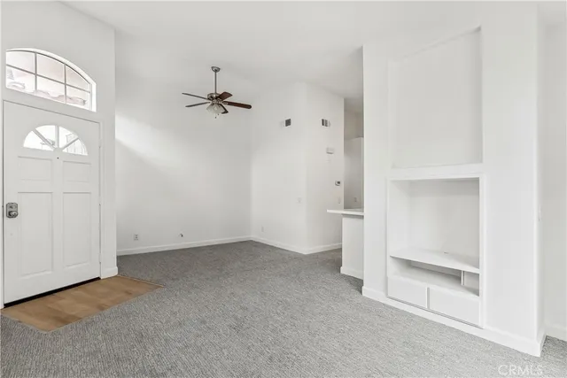 an empty room with windows and closet