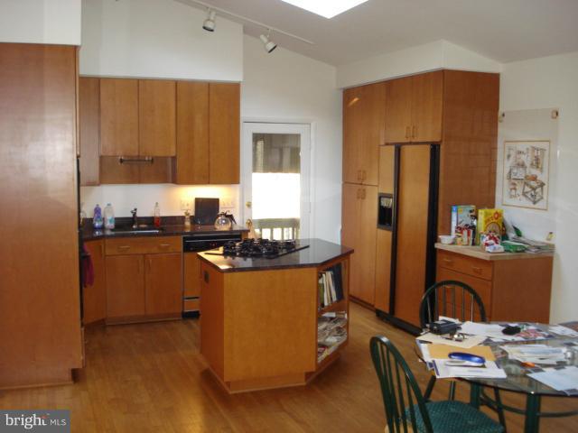 11225 Handlebar Road Reston, VA 20191 - Photo 3 of 20 a kitchen with granite countertop a sink stove and refrigerator