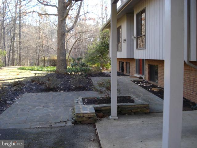 11225 Handlebar Road Reston, VA 20191 - Photo 8 of 20 a view of a patio with table and chairs and floor to ceiling window