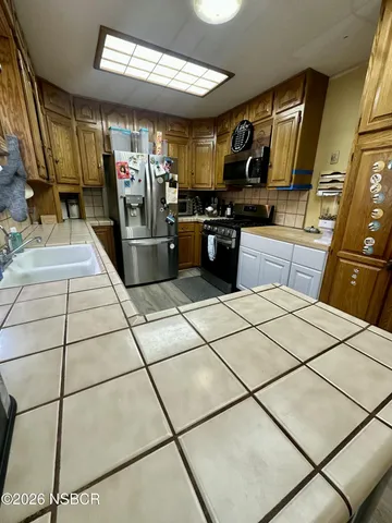 a bedroom with a bed and a dresser in it