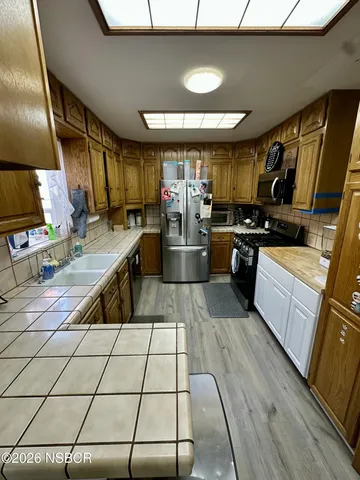 a room with table chairs and wooden floor