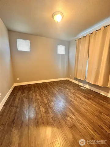 a bathroom with a granite countertop toilet a sink and mirror