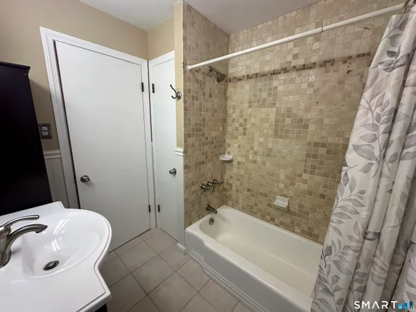 a bathroom with a bathtub and a shower