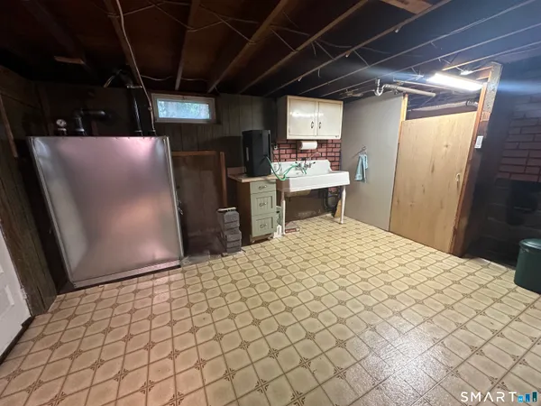 a kitchen with refrigerator and window