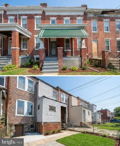 a view of a brick building with many windows and yard