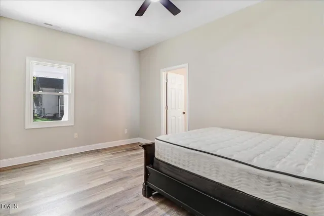 a living room with a bed furniture and chandelier