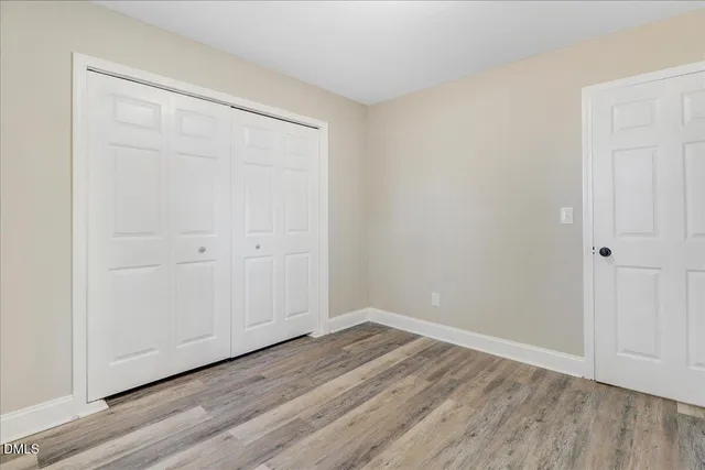a view of a room with wooden floor and window